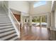 Sun-filled living room with staircase and backyard pool view at 9244 Rhea Dr, Odessa, FL 33556