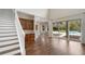 Living room with bar area, staircase and sliding glass doors to pool at 9244 Rhea Dr, Odessa, FL 33556