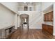 Open living room featuring hardwood floors, staircase, and an entry way leading to the front of the home at 9244 Rhea Dr, Odessa, FL 33556