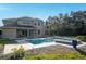 Large pool and spa with a patio, set against a verdant backdrop at 9244 Rhea Dr, Odessa, FL 33556