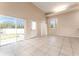 Living room with tile floors and sliding glass doors to backyard at 9406 Citrus Glen Pl, Tampa, FL 33618