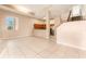 Open living room with tile floors and access to kitchen and patio at 9406 Citrus Glen Pl, Tampa, FL 33618