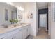 Double vanity bathroom with white cabinets and a walk-in closet at 9813 Crescent Moon Dr, Riverview, FL 33578