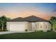 Single-story home with a two-car garage and landscaping at 9813 Crescent Moon Dr, Riverview, FL 33578