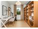 Bright home office features built-in shelving and a workspace with natural light at 9813 Crescent Moon Dr, Riverview, FL 33578
