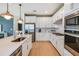 Modern kitchen with white cabinets, stainless steel appliances, and an island at 9813 Crescent Moon Dr, Riverview, FL 33578