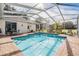 Enclosed rectangular pool with brick patio at 1017 Royal Birkdale Dr, Tarpon Springs, FL 34688