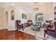 Cozy sitting room with hardwood floors and comfortable seating at 1017 Royal Birkdale Dr, Tarpon Springs, FL 34688