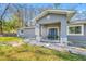 Gray house with stone accents and a covered porch at 11201 Knotty Pine Dr, New Port Richey, FL 34654