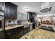 Updated kitchen boasts dark wood cabinets, granite counters, and a farmhouse sink at 11201 Knotty Pine Dr, New Port Richey, FL 34654