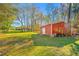 Red metal outbuilding with tires and other items at 11201 Knotty Pine Dr, New Port Richey, FL 34654