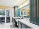 Elegant bathroom with double vanity, granite counters, and walk-in shower at 1170 Wisper Run Ct, Lutz, FL 33558