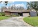 Ranch-style home with stone accents and copper gutters at 1170 Wisper Run Ct, Lutz, FL 33558