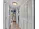 Hallway with light walls and wood-look floors at 11720 Park Blvd # 309, Seminole, FL 33772