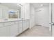 Double vanity bathroom with a large mirror and grey tile at 12213 Tranquil Waters Ter, Parrish, FL 34219