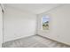 Simple bedroom with gray carpet and window at 12213 Tranquil Waters Ter, Parrish, FL 34219