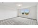 Simple bedroom with gray carpet and windows at 12213 Tranquil Waters Ter, Parrish, FL 34219