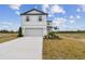 Two-story house with gray driveway and landscaping at 12213 Tranquil Waters Ter, Parrish, FL 34219
