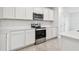 Stainless steel appliances and white cabinets at 12213 Tranquil Waters Ter, Parrish, FL 34219