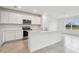 Modern kitchen with white cabinets and island at 12213 Tranquil Waters Ter, Parrish, FL 34219