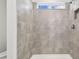 Shower with grey tile and a window above at 12213 Tranquil Waters Ter, Parrish, FL 34219