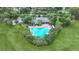 Aerial view of community pool with adjacent clubhouse and lush landscaping at 13613 Newbridge St, Spring Hill, FL 34609