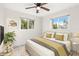 Bedroom with wood-look floors, ceiling fan and large windows at 14198 89Th Ave, Seminole, FL 33776