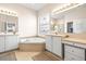 Elegant bathroom featuring a corner tub and double vanity at 15902 Golden Lakes Dr, Wimauma, FL 33598