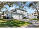 Two-story house with double garage and landscaped lawn at 1600 Gray Bark Dr, Oldsmar, FL 34677