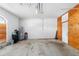 Empty garage with concrete floor, water heater, and storage space at 1600 Gray Bark Dr, Oldsmar, FL 34677