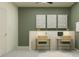 Home office with two desks and green accent wall at 18003 Orange Springs Pl, Tampa, FL 33647