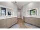 Spacious bathroom with dual vanities and a herringbone tile floor at 1802 97Th Nw St, Bradenton, FL 34209