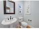 Stylish powder room featuring a pedestal sink and decorative wall art at 1802 97Th Nw St, Bradenton, FL 34209