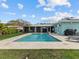 Inviting swimming pool with spacious patio and lush lawn at 1832 San Mateo Dr, Dunedin, FL 34698