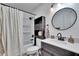 Updated bathroom features a vanity with a quartz countertop, a tub shower combo, and a modern mirror at 1849 Bough Ave # D, Clearwater, FL 33760