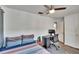 Bright bedroom with striped bedding, a workspace, and ceiling fan at 1849 Bough Ave # D, Clearwater, FL 33760
