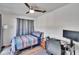 Bedroom with wood flooring and a ceiling fan, offering a workspace at 1849 Bough Ave # D, Clearwater, FL 33760