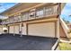 Side view of a two-story condo, double garage, and stairs at 1849 Bough Ave # D, Clearwater, FL 33760