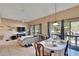 Open living room, dining area, and kitchen with tile floors and patio access at 1849 Bough Ave # D, Clearwater, FL 33760
