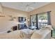 Living room with sectional sofa, tv, and ceiling fan at 1849 Bough Ave # D, Clearwater, FL 33760