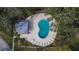 Community pool and lounge area surrounded by trees at 1849 Bough Ave # D, Clearwater, FL 33760