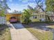 Yellow single story home with carport and driveway at 1905 E Broad St, Tampa, FL 33610