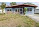 Cute blue house with stone accents and a screened porch at 1907 27Th W St, Bradenton, FL 34205