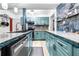 Modern teal kitchen with tile backsplash and stainless steel appliances at 1907 27Th W St, Bradenton, FL 34205