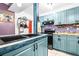 Renovated kitchen, featuring teal cabinets and a unique tile backsplash at 1907 27Th W St, Bradenton, FL 34205