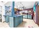 Open kitchen with island and teal cabinets, offering ample counter space at 1907 27Th W St, Bradenton, FL 34205