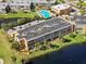 Aerial view of condo building near pool and lake at 225 Country Club Dr # B121, Largo, FL 33771