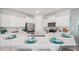 Modern kitchen with white cabinets, stainless steel appliances and large island at 32646 Rustic Rise Rd, San Antonio, FL 33576