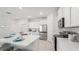 Modern kitchen with white cabinets, stainless steel appliances, and large island at 32646 Rustic Rise Rd, San Antonio, FL 33576