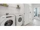 Laundry room with Whirlpool washer and dryer, and additional shelving at 32646 Rustic Rise Rd, San Antonio, FL 33576